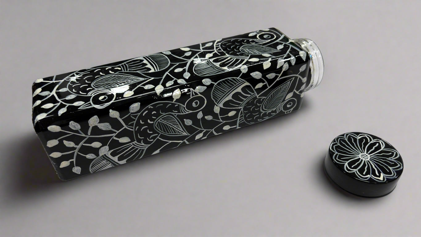 Black and white patterned water bottle on a light gray surface