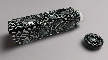 Black and white patterned water bottle on a light gray surface