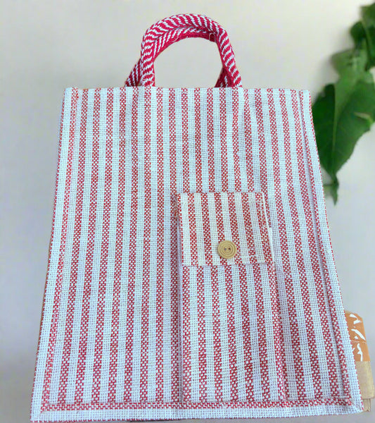 Red and white striped fabric bag with a button on a wooden surface