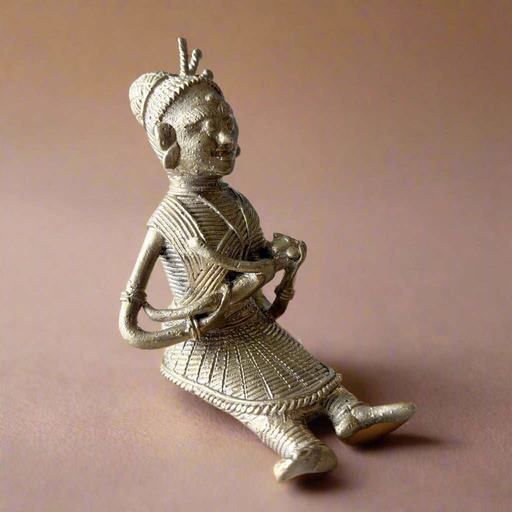 Handcrafted Dokra brass figurine of tribal mother feeding baby, made in Dhenkanal, Odisha