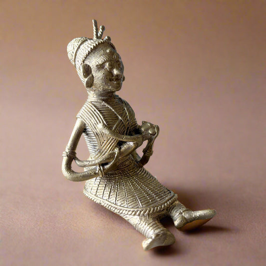 Handcrafted Dokra brass figurine of tribal mother feeding baby, made in Dhenkanal, Odisha