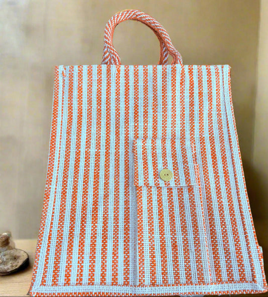Striped bag with orange and white pattern on a wooden surface