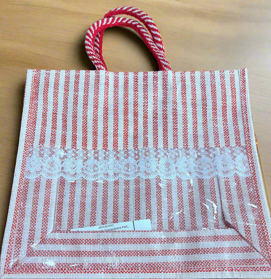 Red and white striped bag with a pattern on a wooden surface