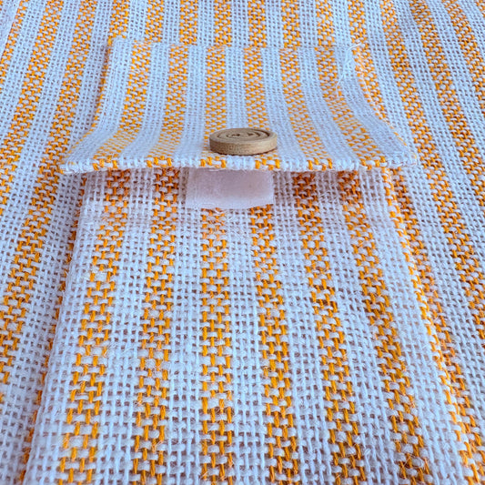 Jute bag with orange and white pattern, featuring a button on top.