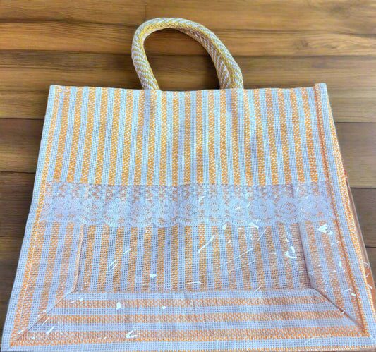 Yellow and white striped woven bag on a wooden surface